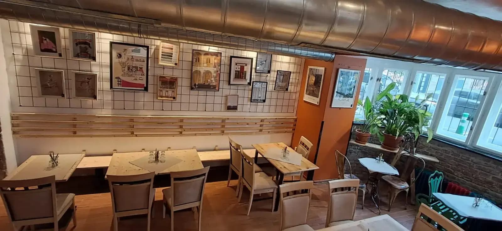 A gallery wall of framed Prague artwork prints in warm light